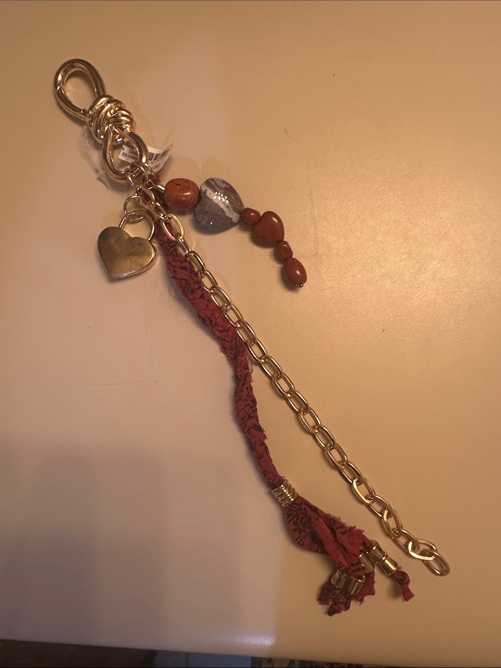 Free People Gold Tone Bag Charm  with Red Fabric Tassel and Heart Beads